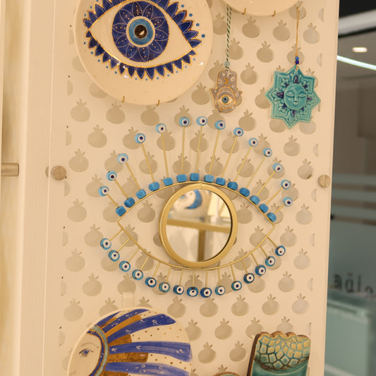 Decorative wall panel with eye designs and other patterns in a store setting