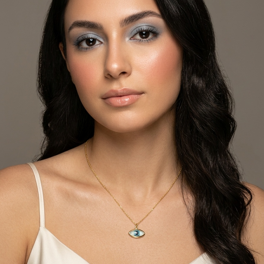 Woman wearing a necklace with a pendant against a neutral background