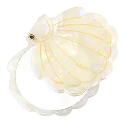 Shell folding hand mirror