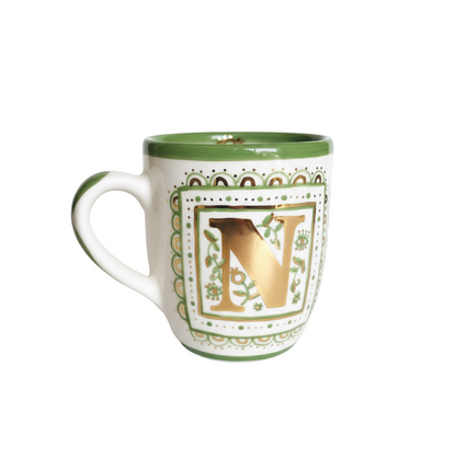 Decorative mug with gold letter 'V' on a white background