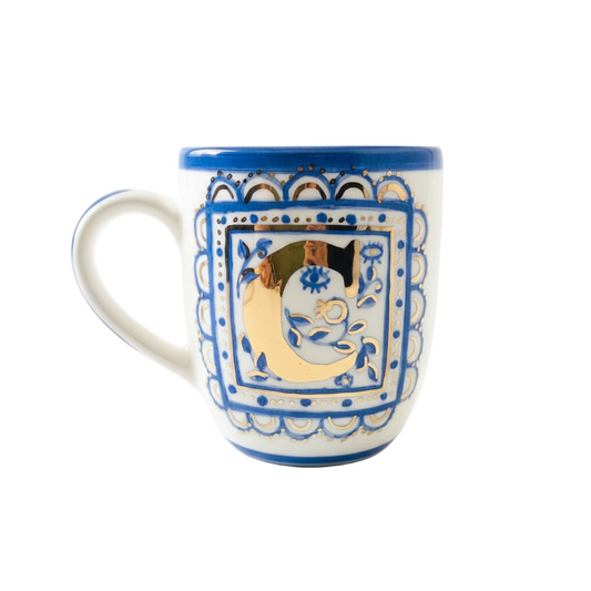 Decorative mug with blue and white pattern on a white background