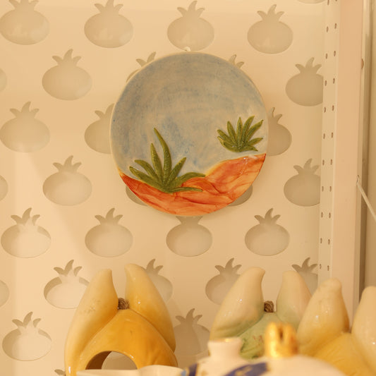 Decorative items including a ceramic duck and a pineapple-shaped object on a textured surface.