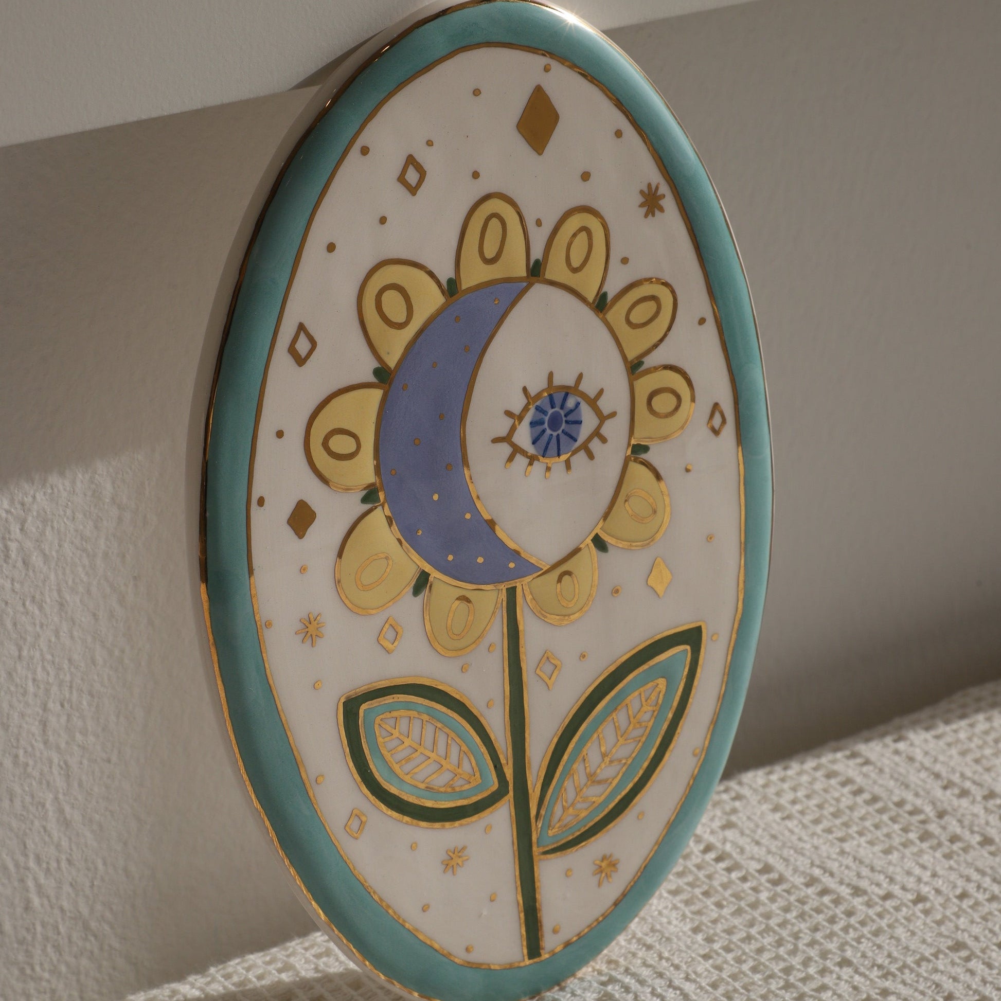 Decorative ceramic plate with floral design on a textured surface