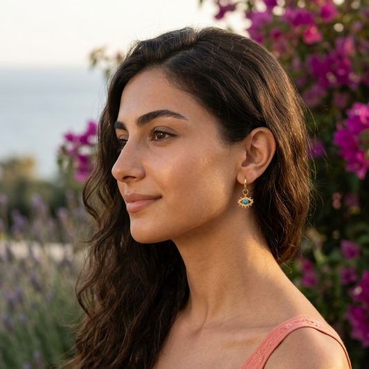 Woman with long dark hair wearing a pink top in a floral setting