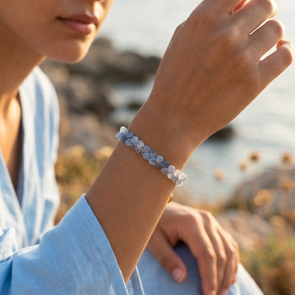 Woman wearing a bracelet outdoors with a blurred natural background