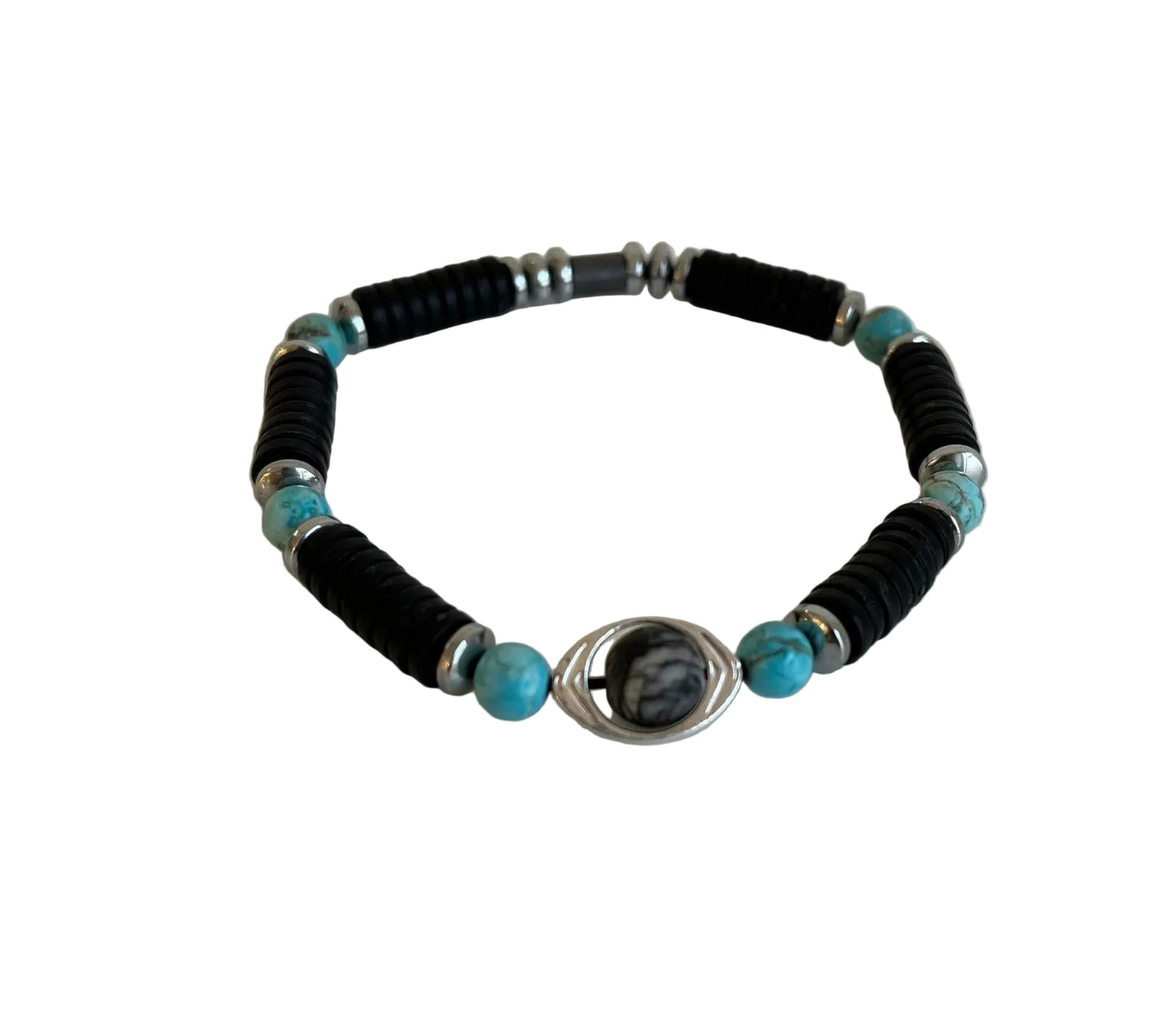 A beaded bracelet featuring black textured cylindrical beads, turquoise blue round beads, silver spacer beads, and a central silver wire-wrapped oval charm with a black and white marbled pattern, displayed on a light off-white background.